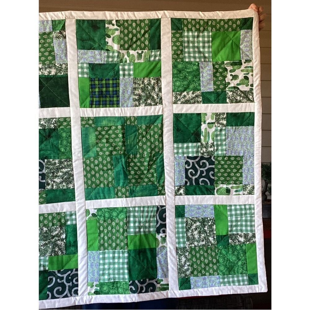 New without tags. Medley of Green Fabrics with White Borders Quilt